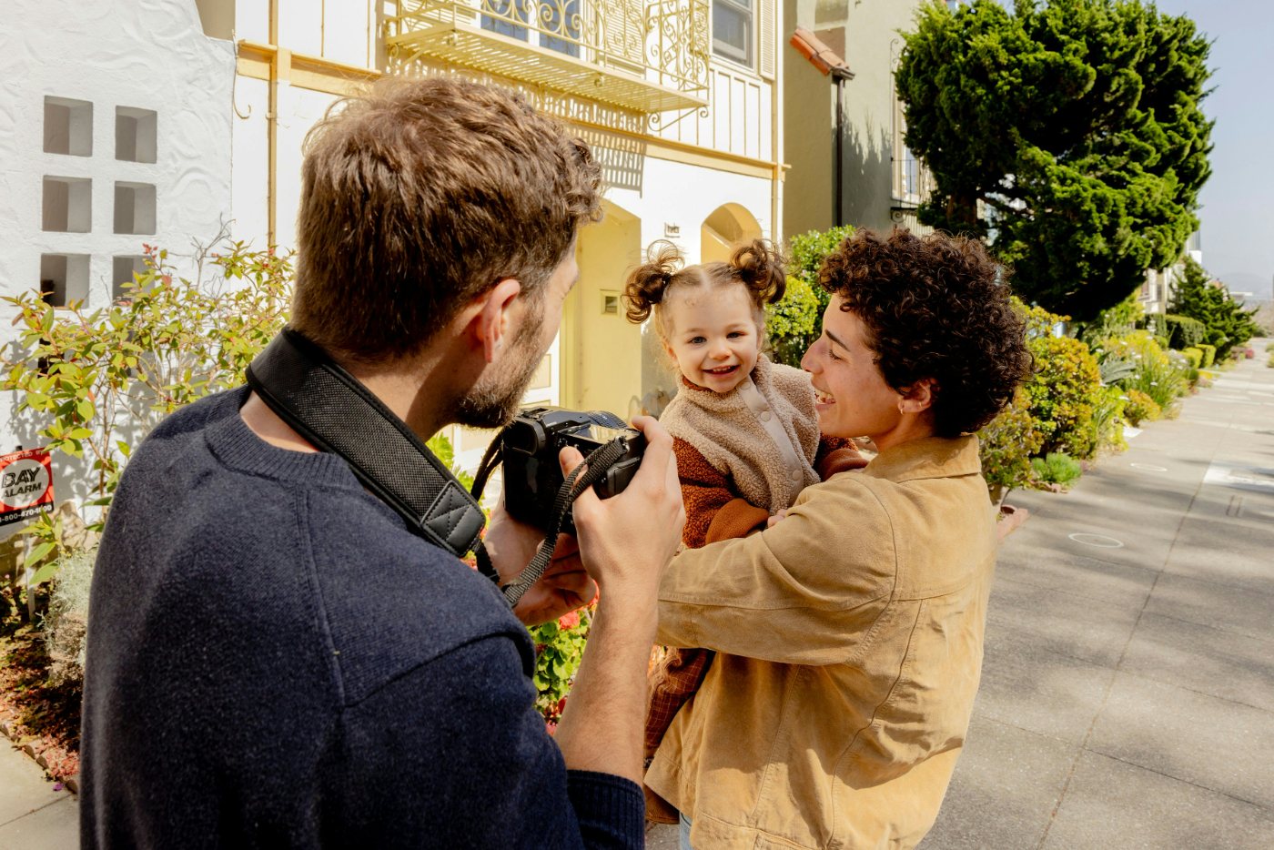 Photographer taking a picture of a smiling child